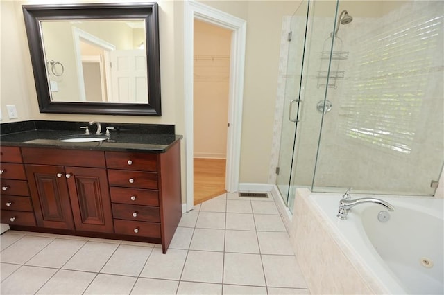 3541 Roswell Rd NE Unit 20, Atlanta, GA 30305 - full bath featuring a shower stall, a jetted tub, vanity, a spacious closet, and tile patterned flooring