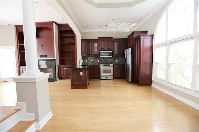 3541 Roswell Rd NE Unit 20, Atlanta, GA 30305 - kitchen with stainless steel appliances, ornamental molding, decorative columns, light wood-type flooring, and a fireplace
