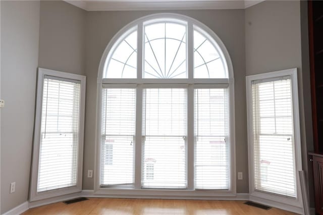 3541 Roswell Rd NE Unit 20, Atlanta, GA 30305 - unfurnished room featuring healthy amount of natural light, light wood-type flooring, and crown molding