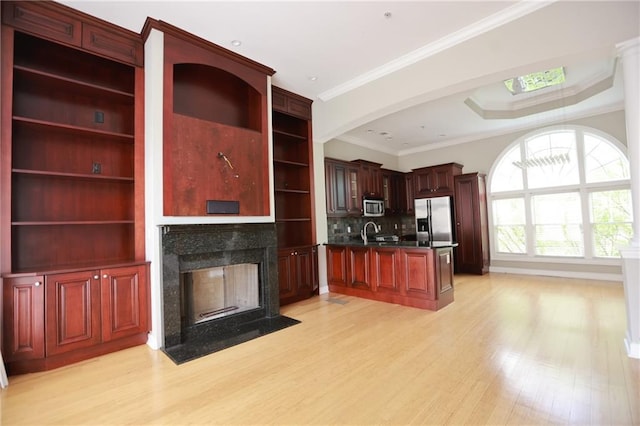 3541 Roswell Rd NE Unit 20, Atlanta, GA 30305 - kitchen with appliances with stainless steel finishes, open shelves, light wood finished floors, dark countertops, and a fireplace
