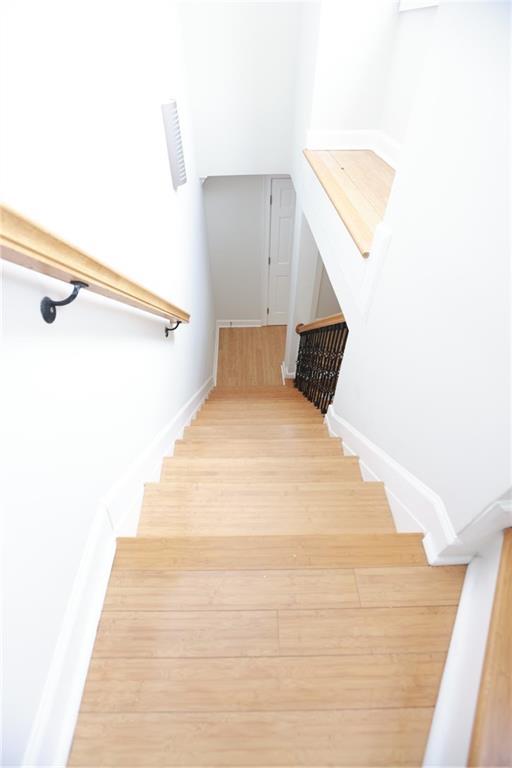 3541 Roswell Rd NE Unit 20, Atlanta, GA 30305 - staircase with wood finished floors and baseboards