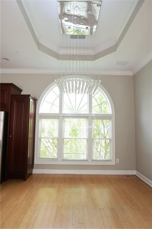 3541 Roswell Rd NE Unit 20, Atlanta, GA 30305 - unfurnished room featuring a chandelier, light wood-type flooring, a raised ceiling, ornamental molding, and baseboards
