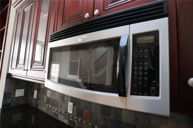 3541 Roswell Rd NE Unit 20, Atlanta, GA 30305 - kitchen view of reddish brown cabinets, backsplash, and dark stone countertops