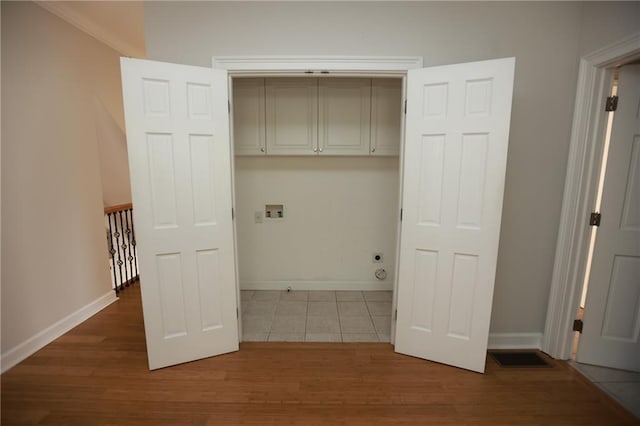 3541 Roswell Rd NE Unit 20, Atlanta, GA 30305 - laundry room featuring cabinet space, baseboards, wood finished floors, and hookup for a washing machine