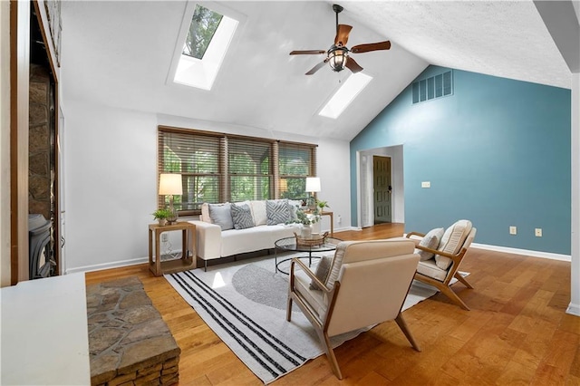 1920 Jett Ridge Rd, Cumming, GA 30041 - living room featuring a skylight, ceiling fan, wood finished floors, baseboards, and high vaulted ceiling