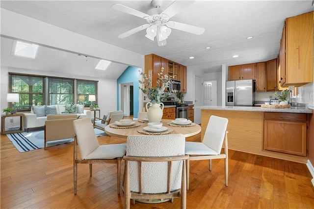 1920 Jett Ridge Rd, Cumming, GA 30041 - dining room featuring a skylight, light wood finished floors, lofted ceiling, recessed lighting, and ceiling fan