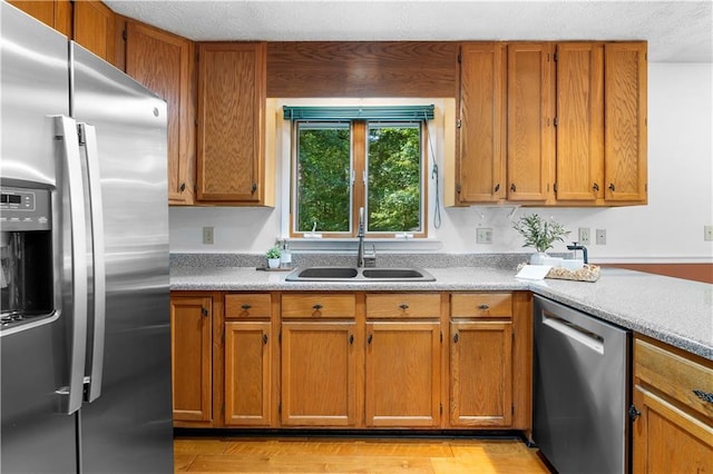 1920 Jett Ridge Rd, Cumming, GA 30041 - kitchen featuring appliances with stainless steel finishes, a sink, light countertops, and brown cabinetry