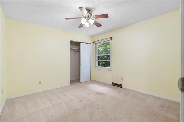 1920 Jett Ridge Rd, Cumming, GA 30041 - unfurnished bedroom with light colored carpet, baseboards, a closet, ceiling fan, and a textured ceiling