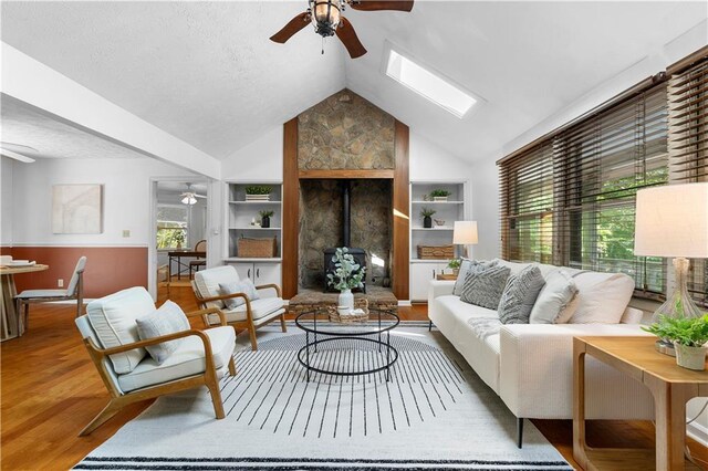 1920 Jett Ridge Rd, Cumming, GA 30041 - living area with ceiling fan, built in features, plenty of natural light, vaulted ceiling, and a textured ceiling