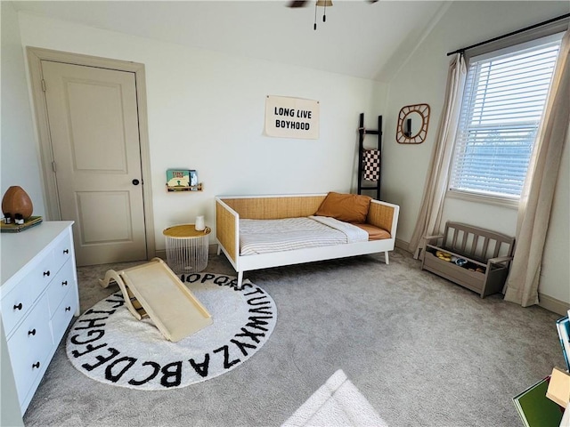 bedroom featuring lofted ceiling and carpet flooring