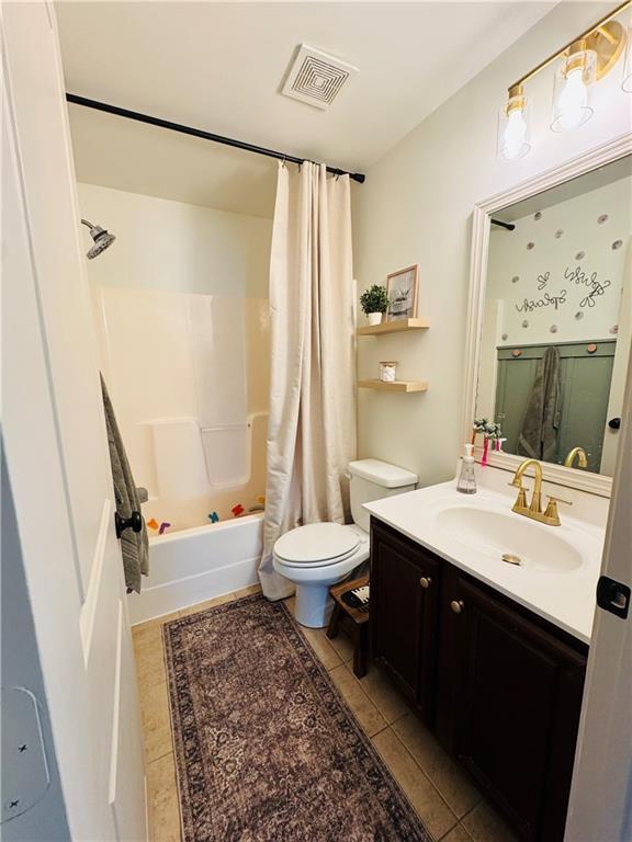 bathroom with tile patterned floors, visible vents, toilet, shower / bath combo, and vanity