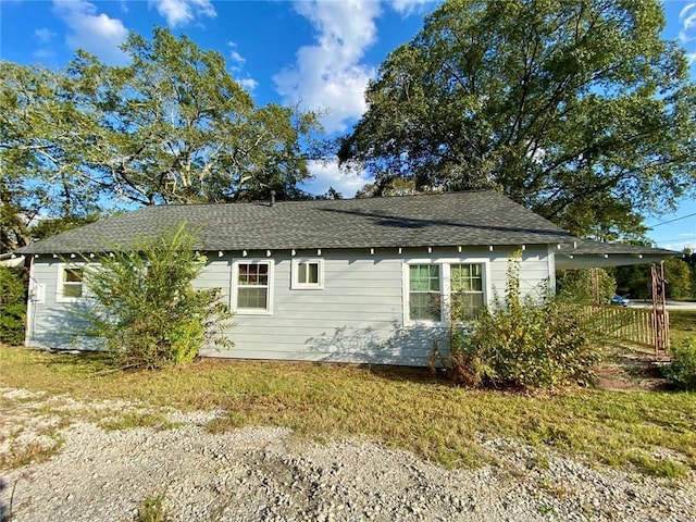 view of side of home featuring a carport