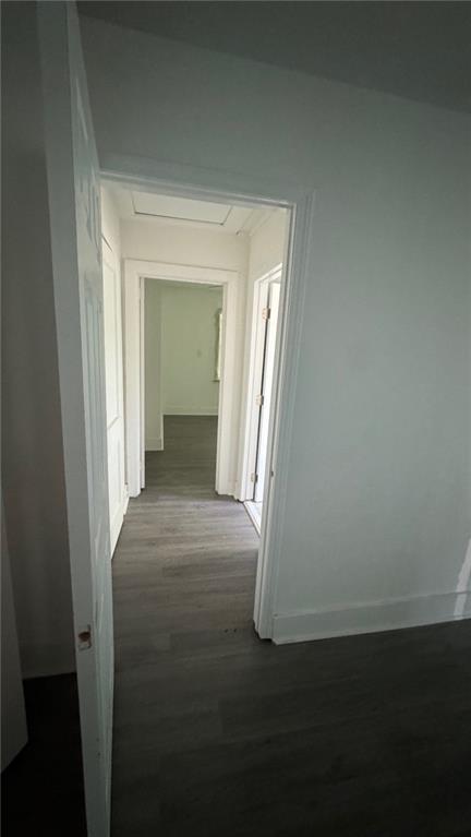 corridor with dark wood-type flooring