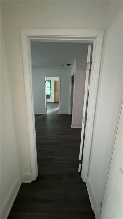 corridor featuring dark hardwood / wood-style floors