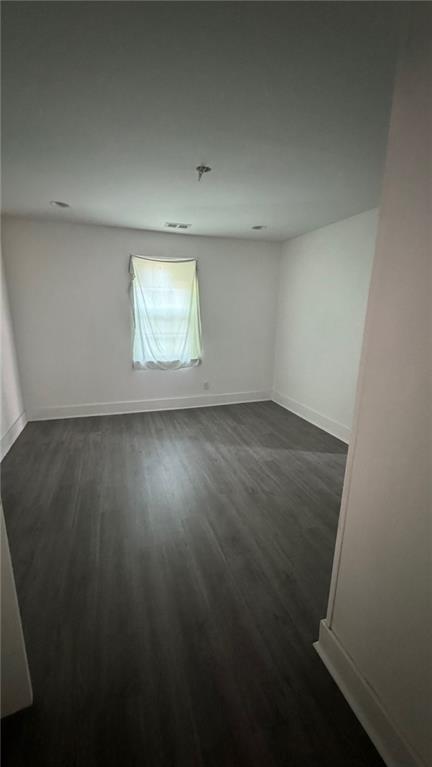 empty room featuring dark hardwood / wood-style floors