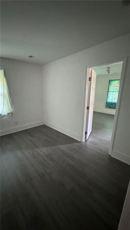 spare room with dark hardwood / wood-style flooring