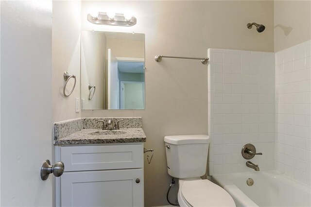 full bathroom with vanity, toilet, and tiled shower / bath