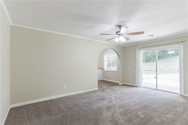 spare room with a textured ceiling, ceiling fan, ornamental molding, and carpet flooring