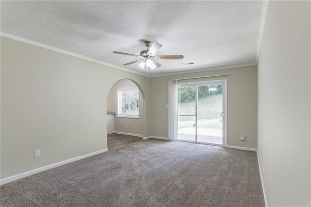 carpeted spare room featuring ceiling fan, a textured ceiling, and crown molding