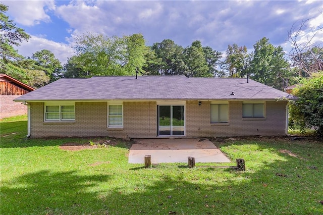 rear view of property with a patio and a lawn