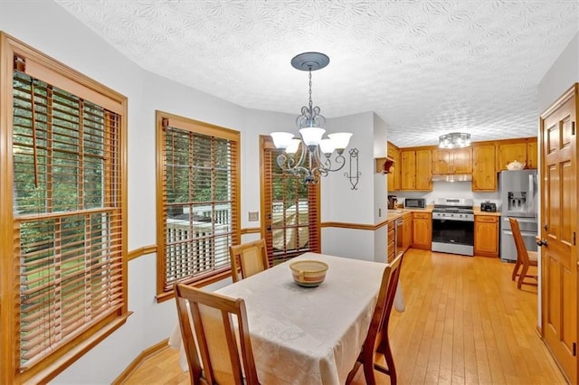 40 Picketts Forge Dr W, Acworth, GA 30101 - dining area with a chandelier, light wood-style floors, and a textured ceiling