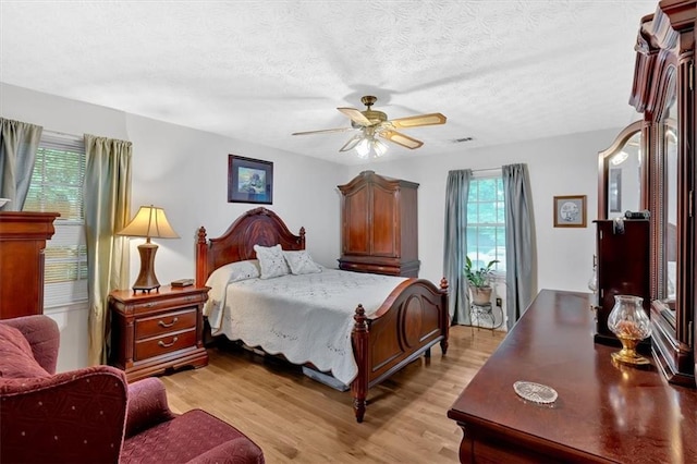 40 Picketts Forge Dr W, Acworth, GA 30101 - bedroom with light wood-style floors, a textured ceiling, and a ceiling fan