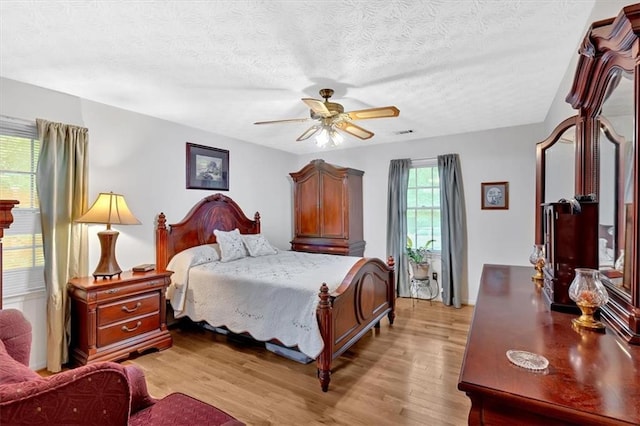 40 Picketts Forge Dr W, Acworth, GA 30101 - bedroom featuring light wood-style floors, a textured ceiling, and a ceiling fan