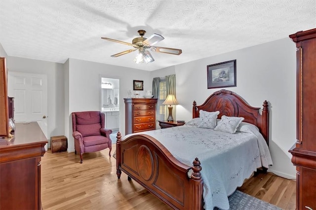 40 Picketts Forge Dr W, Acworth, GA 30101 - bedroom with light wood-type flooring, a textured ceiling, a ceiling fan, and ensuite bathroom