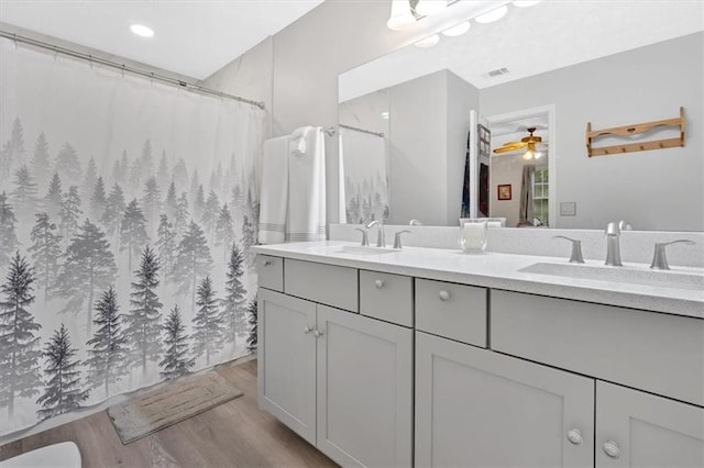 40 Picketts Forge Dr W, Acworth, GA 30101 - bathroom featuring wood finished floors, double vanity, a ceiling fan, and a shower with shower curtain