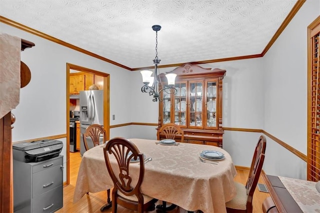 40 Picketts Forge Dr W, Acworth, GA 30101 - dining room with light wood-style flooring, a chandelier, ornamental molding, and a textured ceiling