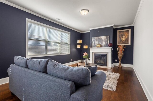 living room featuring dark hardwood / wood-style floors and ornamental molding