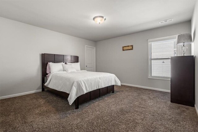 bedroom with dark carpet