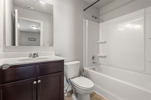 full bathroom with bathing tub / shower combination, tile patterned flooring, vanity, and toilet