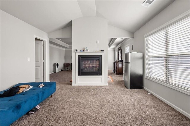 carpeted living room featuring lofted ceiling