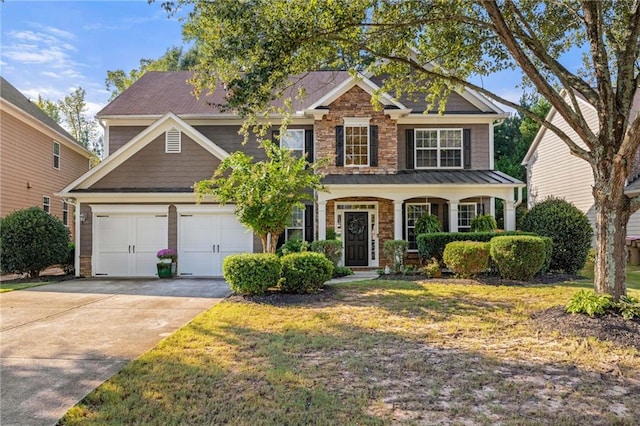 view of front facade featuring driveway, stone siding, a garage, and a front lawn