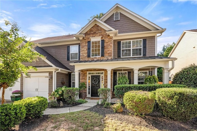 view of front of house featuring a garage, a standing seam roof, a porch, and metal roof