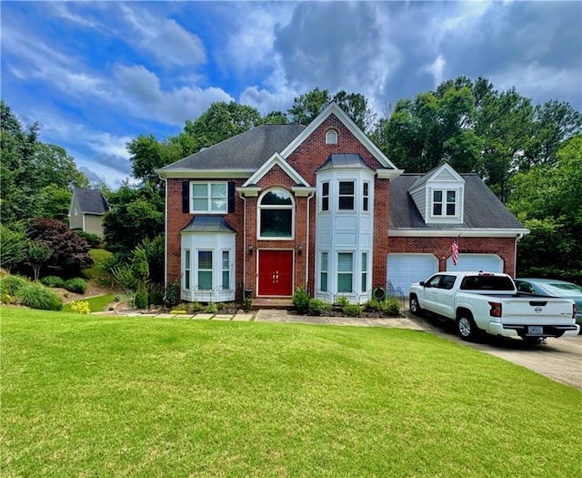 703 Overlook Pt, Woodstock, GA 30189 - view of front of property featuring brick siding, a front lawn, an attached garage, and driveway