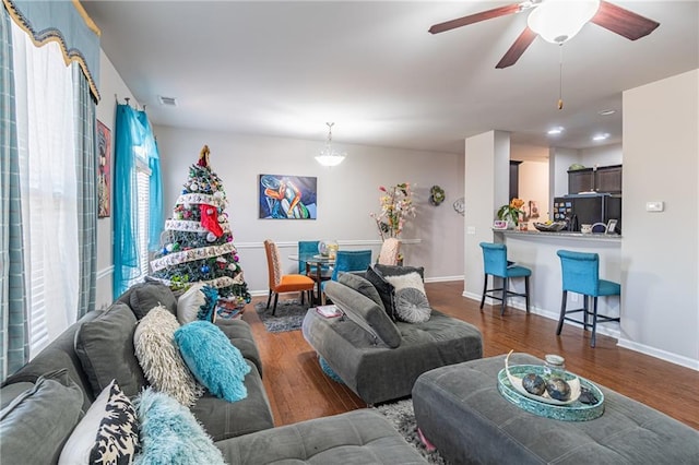 living room featuring dark hardwood / wood-style floors and ceiling fan