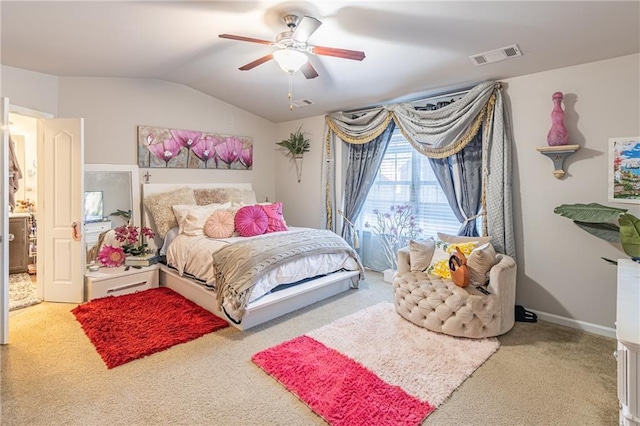 carpeted bedroom with ceiling fan and vaulted ceiling