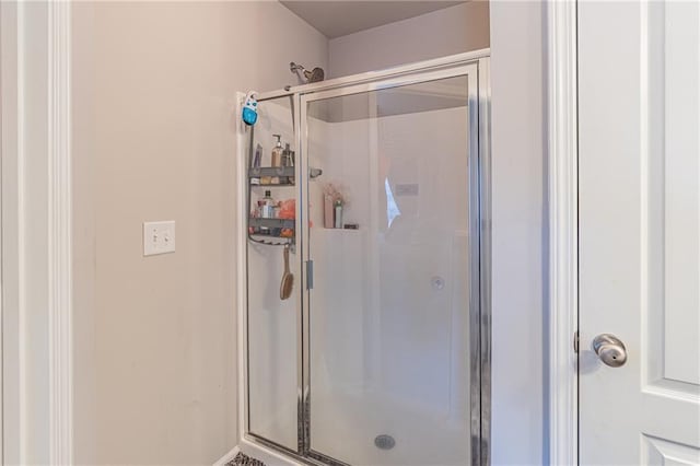 bathroom featuring a shower with door