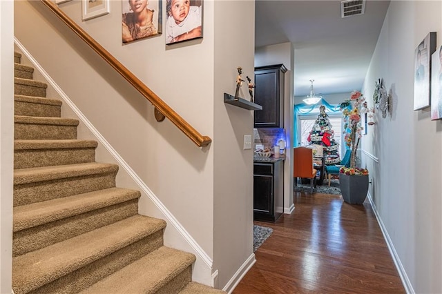 stairway with hardwood / wood-style floors