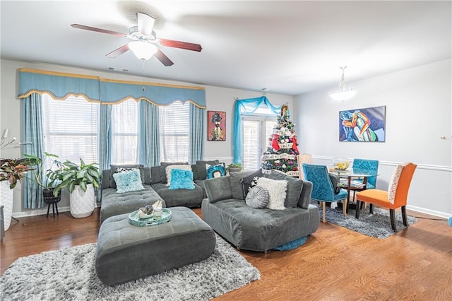 living room with wood-type flooring and ceiling fan