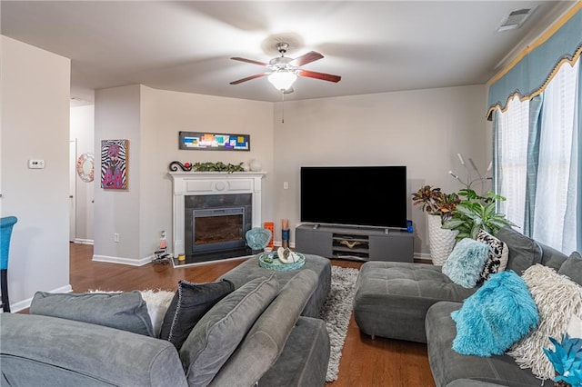 living room featuring dark hardwood / wood-style flooring and ceiling fan