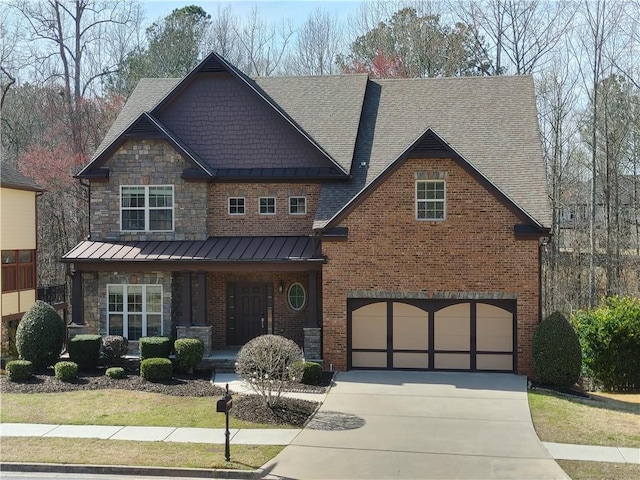 craftsman inspired home featuring a garage, driveway, a standing seam roof, covered porch, and brick siding