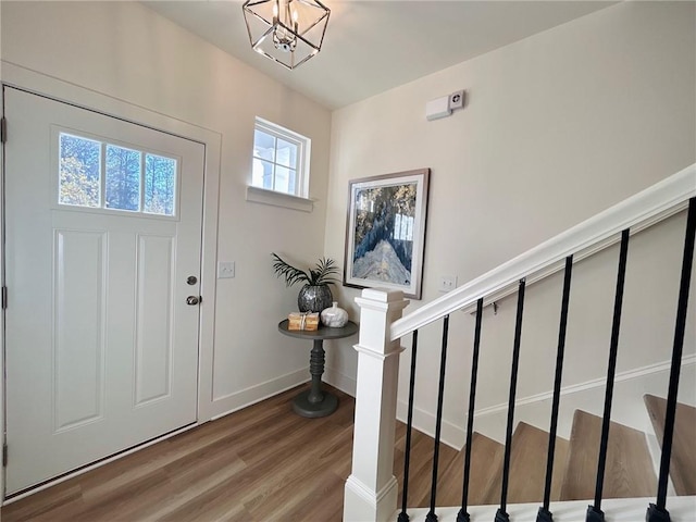 entrance foyer featuring hardwood / wood-style flooring and a notable chandelier