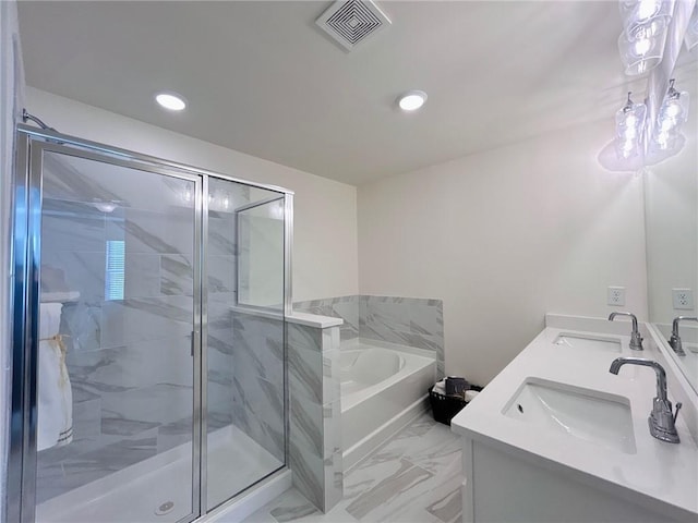 bathroom featuring vanity and shower with separate bathtub