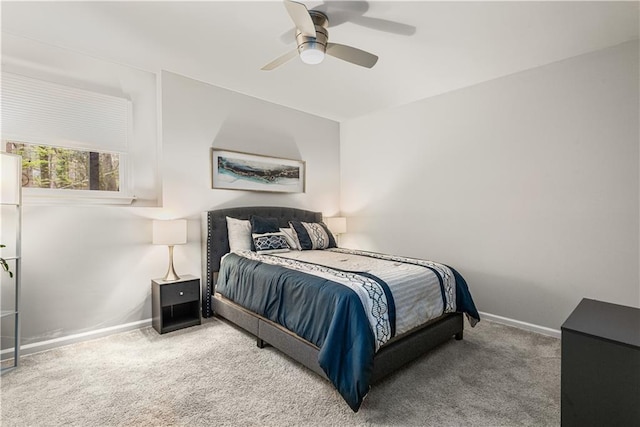 carpeted bedroom with baseboards and a ceiling fan