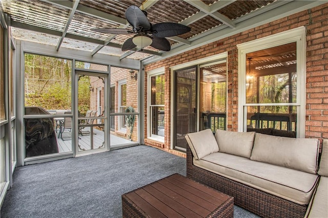 unfurnished sunroom featuring a ceiling fan and a wealth of natural light