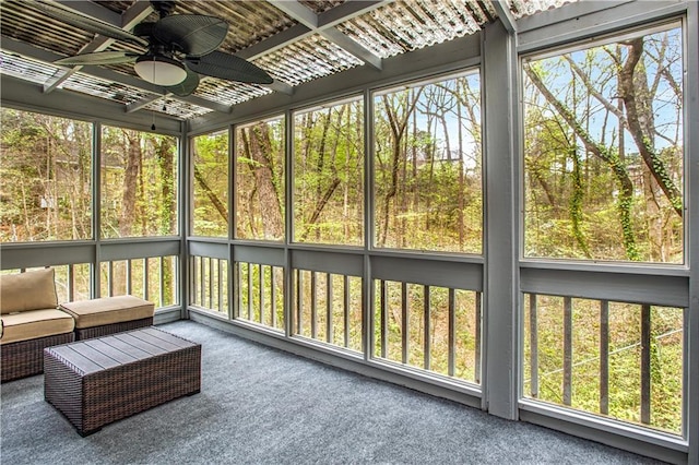 unfurnished sunroom with ceiling fan