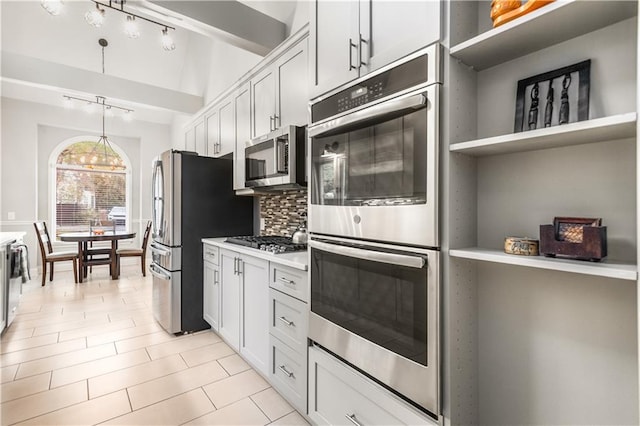 kitchen with open shelves, light countertops, white cabinets, appliances with stainless steel finishes, and tasteful backsplash